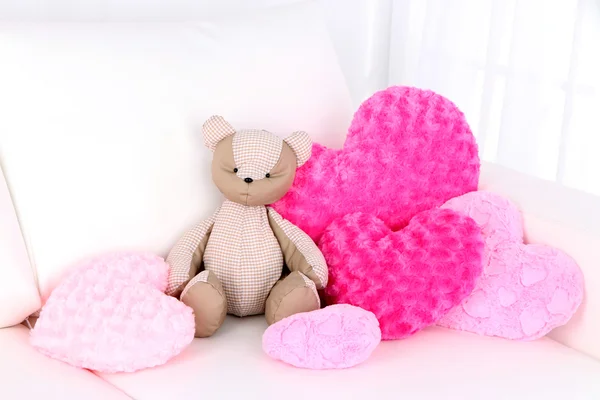 Bear toy with pillows on sofa — Stock Photo, Image