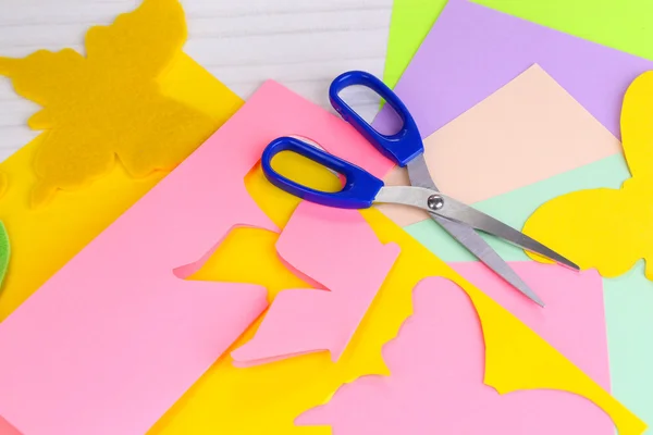 Women hand cutting colorful paper with scissors — Stock Photo, Image