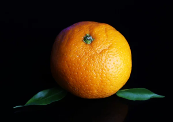 Ripe sweet tangerine, on dark color background — Stock Photo, Image