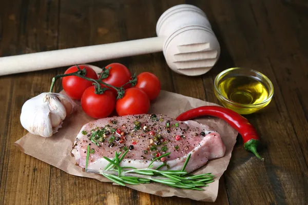 Raw meat steak with spices  herbs, on wooden background — Stock Photo, Image