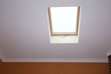 Roof skylight in new modern attic room  clipart