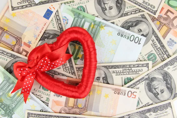 Love and money concept. Heart on European and American money — Stock Photo, Image