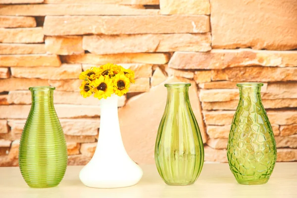 Different decorative vases on shelf on brick wall background — Stock Photo, Image