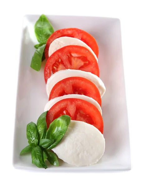 Sałatka Caprese ser mozarella, pomidory i bazylia na talerzu, na białym tle — Zdjęcie stockowe