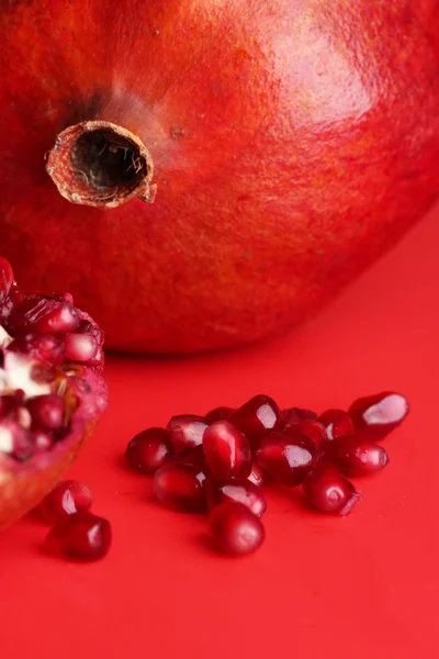 Ripe pomegranates on red background — Stock Photo, Image