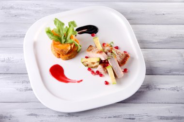 kızarmış patates ve kemik iliği parçaları ve ahşap masa arka plaka üzerine nar taneleri ile ızgara et