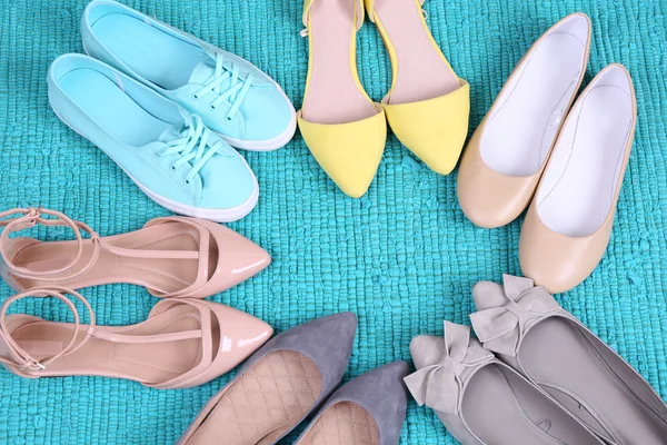 Female fashion shoes on blue carpet — Stock Photo, Image