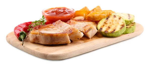 Grilled steak with fried potato pieces and grilled vegetables  on wooden board, isolated on white — Stock Photo, Image