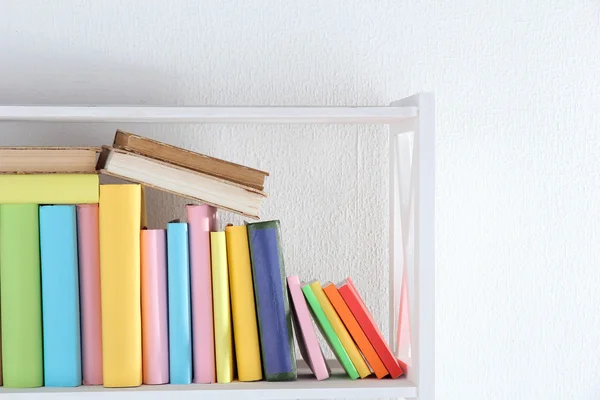 Books on white shelf in room — Stock Photo, Image