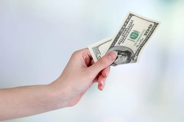 Dollars in hand on bright background — Stock Photo, Image