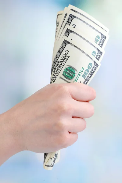 Dollars in hand on bright background — Stock Photo, Image