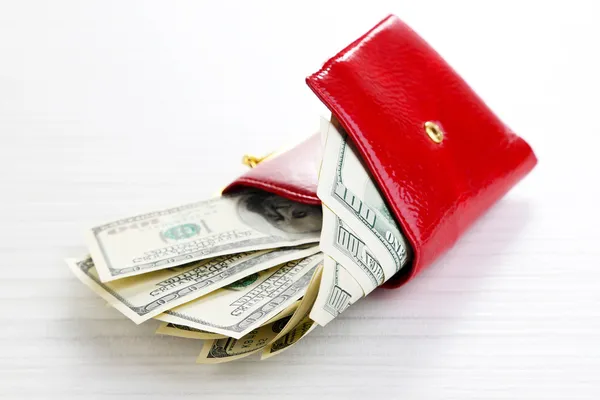 Purse with dollars banknotes on wooden table — Stock Photo, Image