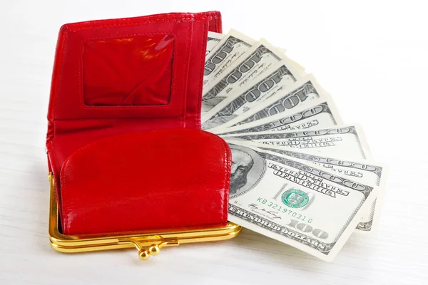 Purse with dollars banknotes on wooden table — Stock Photo, Image