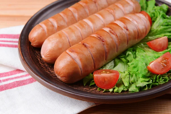 Grilled sausage on plate on table close-up — Stock Photo, Image