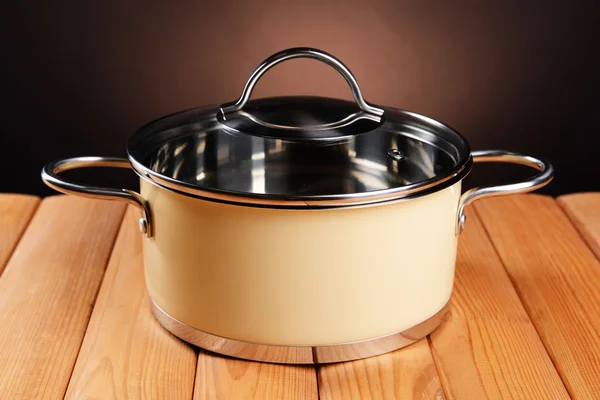 Pan on table on brown background — Stock Photo, Image