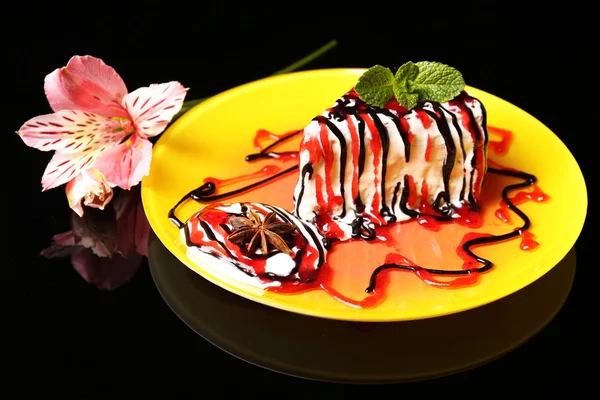 Tasty cake with cream, on black background — Stock Photo, Image