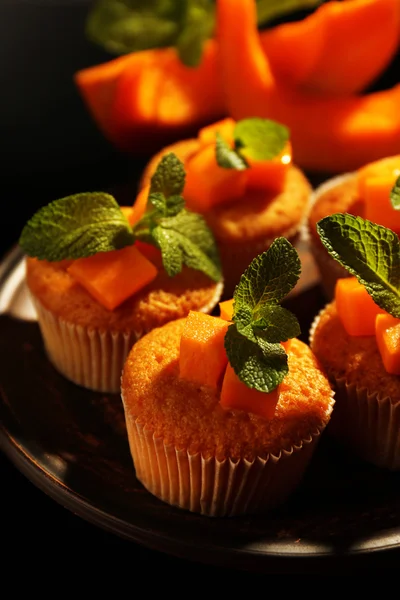 Tasty pumpkin muffins on dark background — Stock Photo, Image