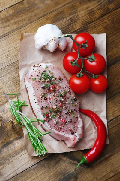 Raw meat steak with spices  herbs, on wooden background — Stock Photo, Image