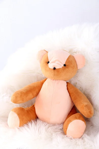 Bear toy on armchair in room — Stock Photo, Image