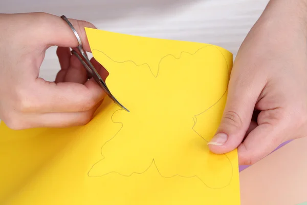 Women hand cutting colorful paper with scissors — Stock Photo, Image