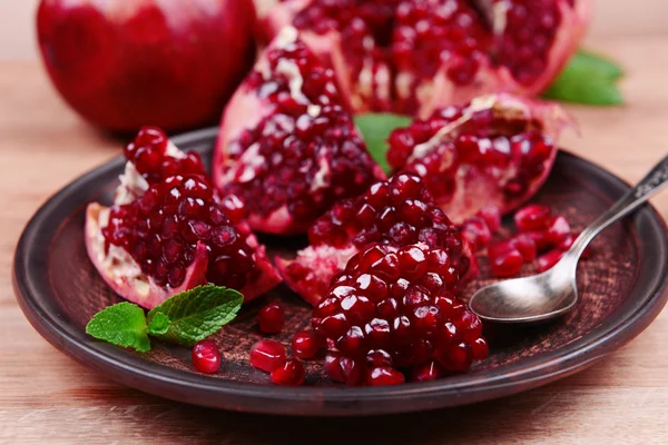 Ripe pomegranates on table close-up — Stock Photo, Image