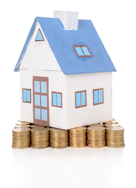 House standing on heap of coins isolated on white — Stock Photo, Image