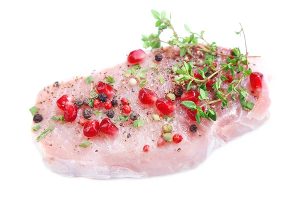 Raw meat steak with herbs, spices and pomegranate seeds, isolated on white — Stock Photo, Image