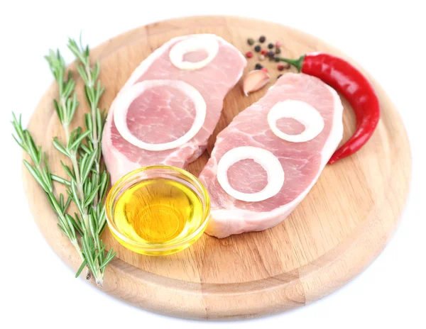 Raw meat steak with herbs, spices, onion rings on cutting board, isolated on white — Stock Photo, Image