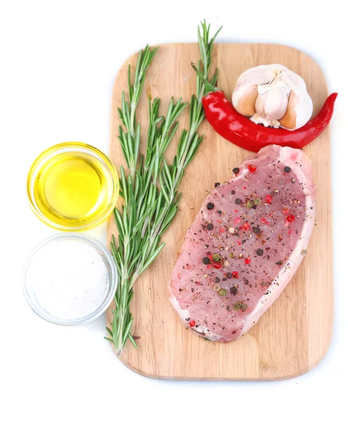 Raw meat steak with herbs and spices on cutting board, isolated on white — Stock Photo, Image