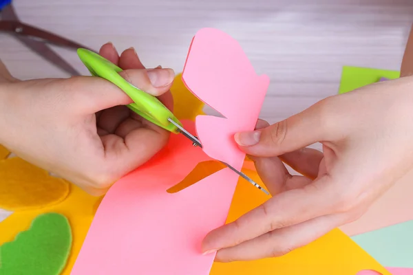 Women hand cutting colorful paper with scissors — Stock Photo, Image