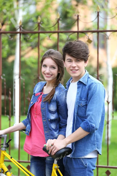 Young couple with bicycle outside — Stock Photo, Image