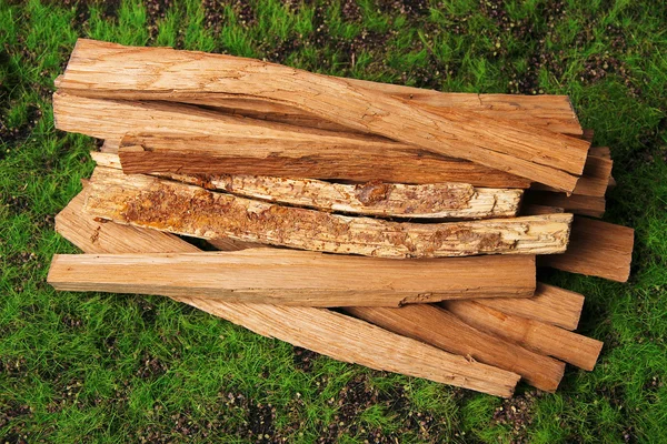 Stack of firewood on grass close up — Stock Photo, Image