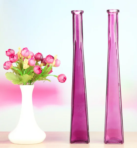 Different decorative vases on shelf on light background — Stock Photo, Image