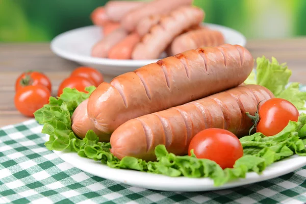 Grilled sausage on plate on table close-up — Stockfoto