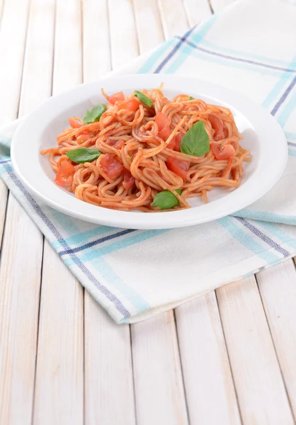 Pasta with tomato sauce on plate on table close-up — Stock Photo, Image