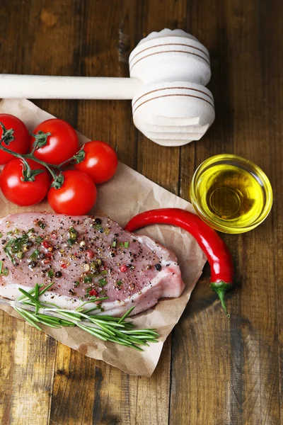 Raw meat steak with spices  herbs, on wooden background — Stock Photo, Image