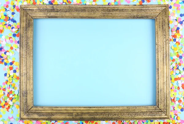 Photoframe with confetti on blue background — Stock Photo, Image