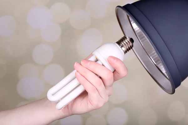 Hand changing light bulb for lamp at home — Stock Photo, Image