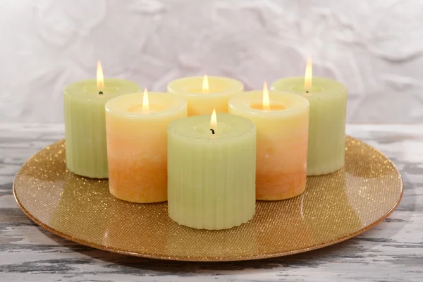 Hermosas velas en la mesa sobre fondo gris — Foto de Stock