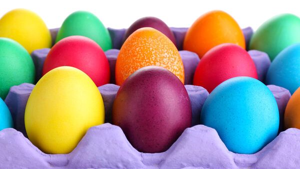 Colorful Easter eggs in tray close up