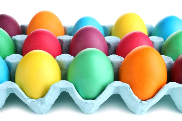 Colorful Easter eggs in tray isolated on white — Stock Photo, Image