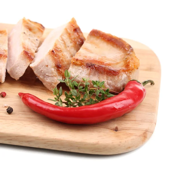 Grilled steak with fried potato pieces and grilled vegetables  on wooden board, isolated on white — Stock Photo, Image