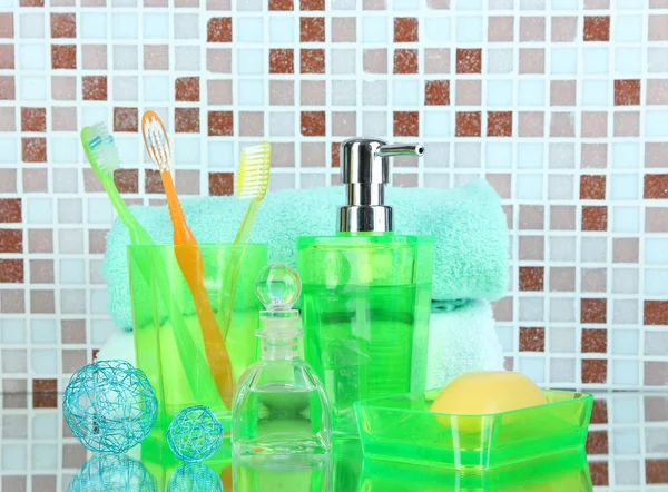 Cosmetics and bath accessories on mosaic tiles background — Stock Photo, Image