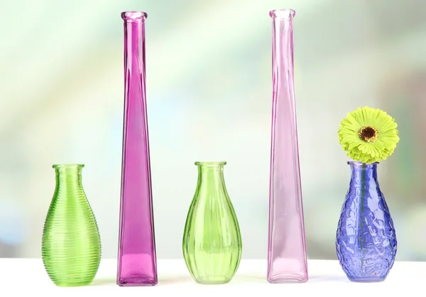 Different decorative vases on shelf on light background — Stock Photo, Image