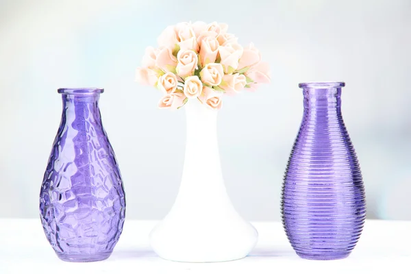 Different decorative vases on shelf on light background — Stock Photo, Image