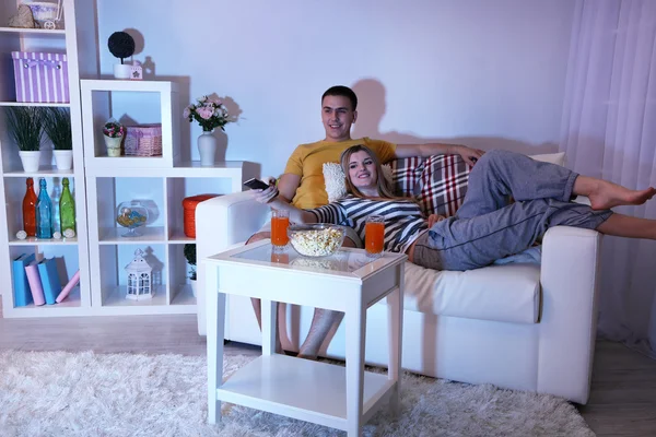 Young couple watching television at home of blacking-out — Stock Photo, Image