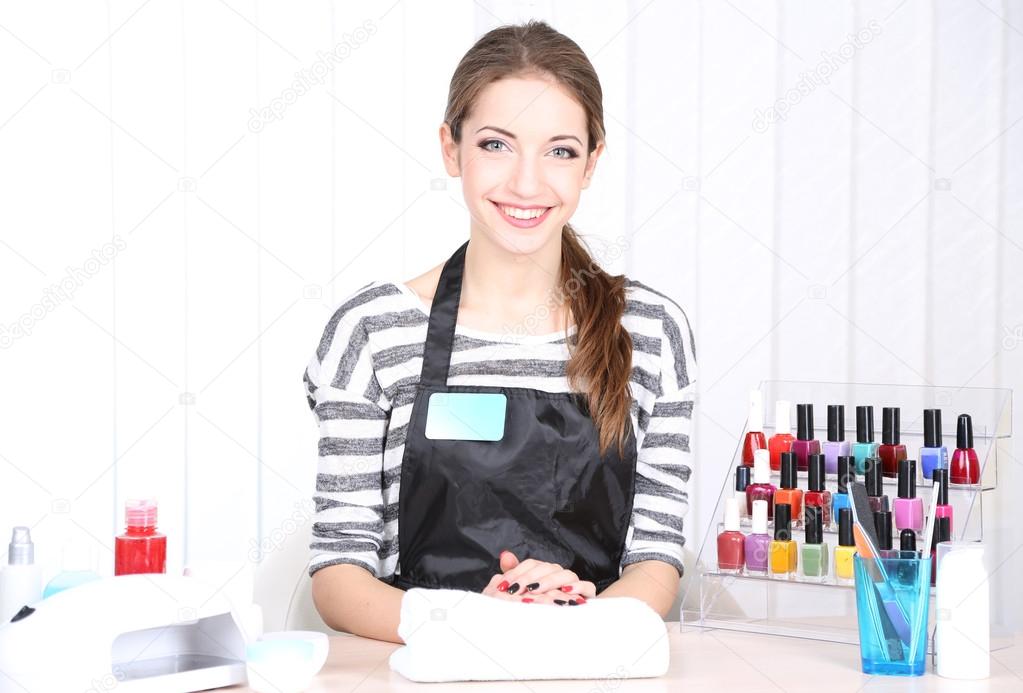 Beautiful girl manicurist in beauty salon