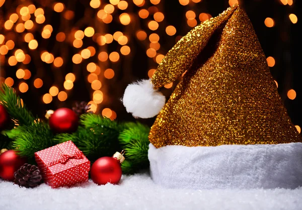 Santa hat on snow on lights background — Stock Photo, Image