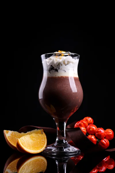 Tasty dessert with chocolate, cream and orange sauce, isolated on black — Stock Photo, Image