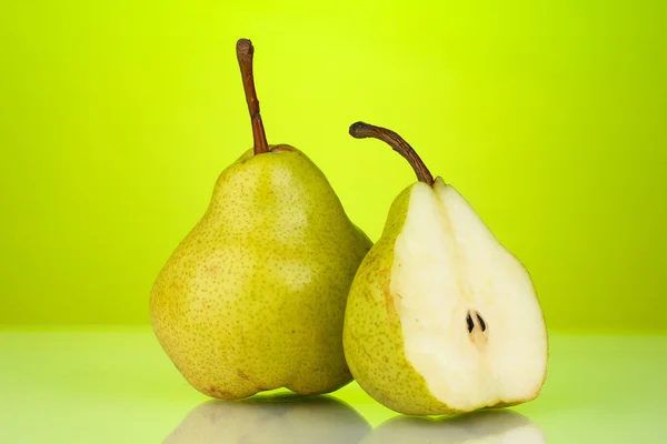 Ripe pears on bright green background Royalty Free Stock Images